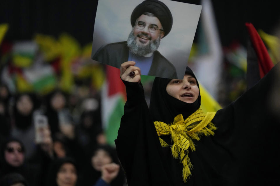 A woman shouts slogans, as she holds a portrait for Hezbollah leader Sayyed Hassan Nasrallah during a rally to mark Jerusalem day, in a southern suburb of Beirut, Lebanon, Friday, April 14, 2023. Since Iran's Islamic Revolution in 1979, the rallies marking what is also known as al-Quds Day have typically been held on the last Friday of the Muslim holy month of Ramadan. (AP Photo/Hussein Malla)