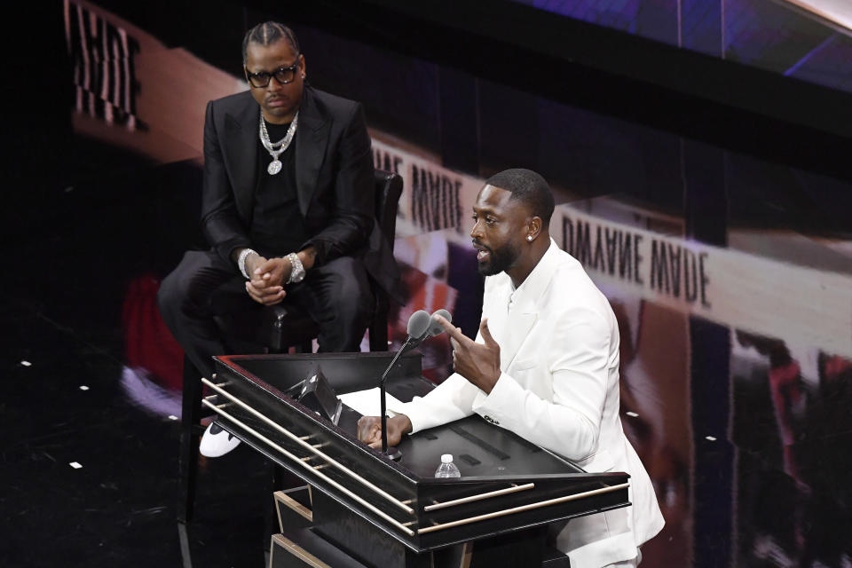 Dwyane Wade speaks during his enshrinement at the Basketball Hall of Fame as presenter Allen Iverson, left, listens Saturday, Aug. 12, 2023, in Springfield, Mass. (AP Photo/Jessica Hill)