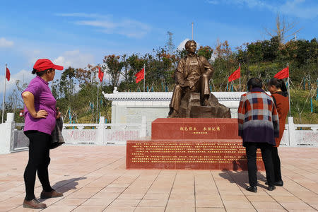 Women visit a statue of late Chinese chairman Mao Zedong in Shazhou village, Rucheng county, Hunan province, China December 3, 2018. Picture taken December 3, 2018. REUTERS/Shu Zhang