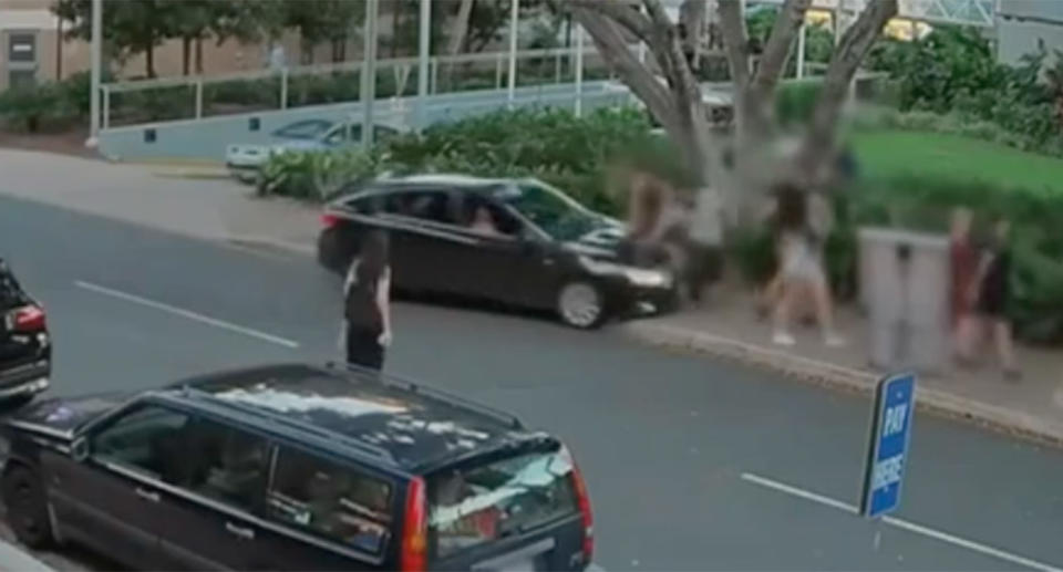 <span>A black car mounted the footpath at South Bank and drove straight into pedestrians</span>. Source: 7 News