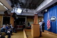 Assistant Attorney General for Civil Rights Kristen Clarke, second from right, accompanied by Attorney General Merrick Garland, right, speaks at a news conference at the Department of Justice in Washington, Thursday, Aug. 5, 2021, to announce that the Department of Justice is opening an investigation into the city of Phoenix and the Phoenix Police Department. (AP Photo/Andrew Harnik)