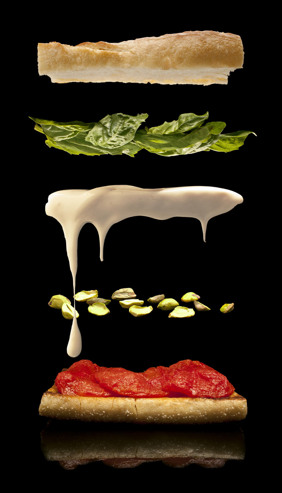 This undated illustration provided by Modernist Cuisine on July 16, 2013 shows goat cheese on a baguette with tomato confit and basil. (AP Photo/Modernist Cuisine, Chris Hoover)