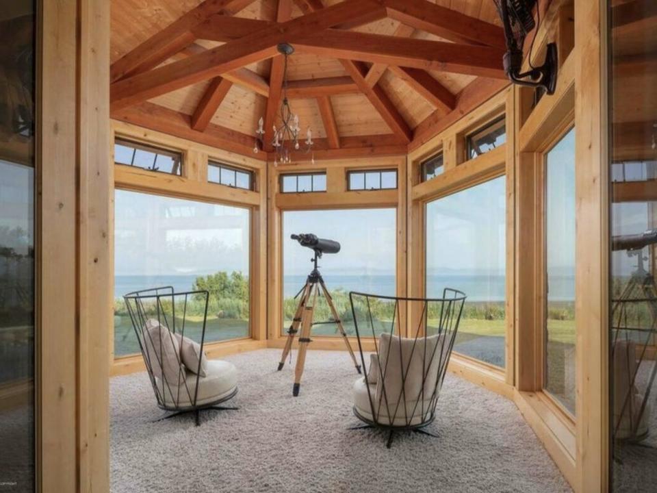 Conservatory with panoramic windows, 2 chairs, and a telescope