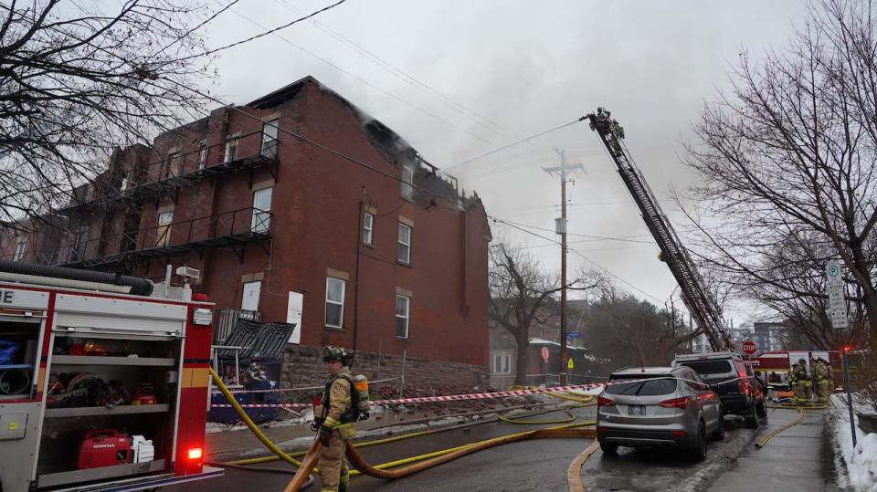 Ottawa firefighters at a burning building at the corner of Sweetland Avenue and Osgoode Street in Sandy Hill Feb. 1, 2024.