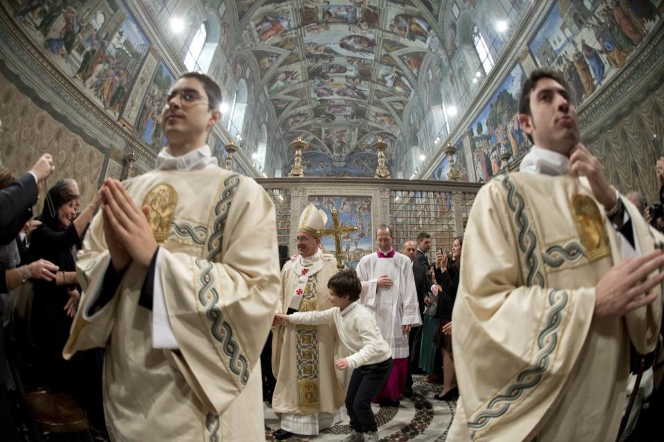 Pope Francis leaves at the end of a mass where 32 babies were baptized in the Sistine Chapel at the Vatican January 12, 2014, in this handout courtesy of Osservatore Romano. REUTERS/Osservatore Romano/Handout via Reuters (VATICAN - Tags: RELIGION) ATTENTION EDITORS - THIS IMAGE WAS PROVIDED BY A THIRD PARTY. FOR EDITORIAL USE ONLY. NOT FOR SALE FOR MARKETING OR ADVERTISING. THIS PICTURE IS DISTRIBUTED EXACTLY AS RECEIVED BY REUTERS, AS A SERVICE TO CLIENTS. NO SALES. NO ARCHIVES