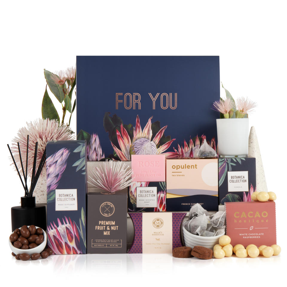 A collection of gifts from a hamper including a card saying 