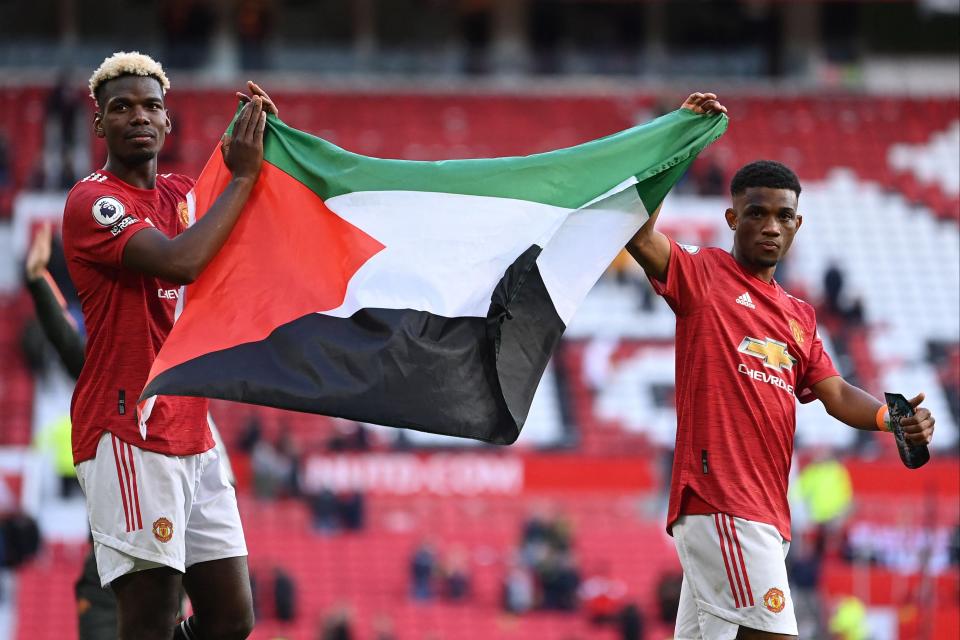 <p>Pogba and Amad display the Palestinian flag</p> (POOL/AFP via Getty Images)