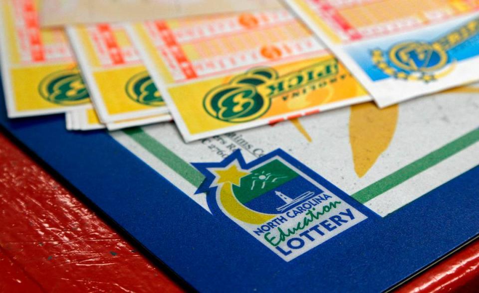 In this Thursday, July 17, 2014 photo, lottery tickets line the counter area at Eagles Express in Knightdale, N.C. North Carolinas lottery has steadily grown over its first decade and its leaders say it has room to grow even more in the coming years. (AP Photo/Gerry Broome)