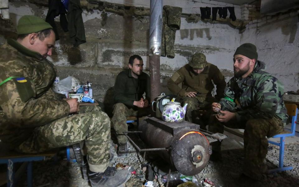 Ukrainian servicemen sit in a shelter near the city of Izyum, Kharkiv - STR/EPA-EFE/Shutterstock 