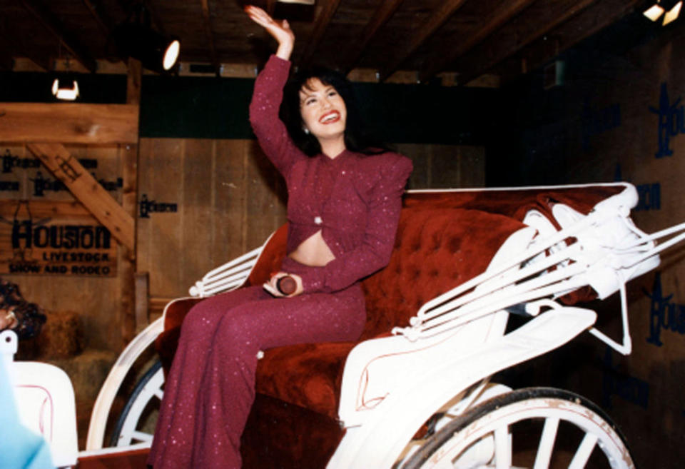 Selena rides in a carriage during a performance at the Houston Livestock Show & Rodeo at the Houston Astrodome