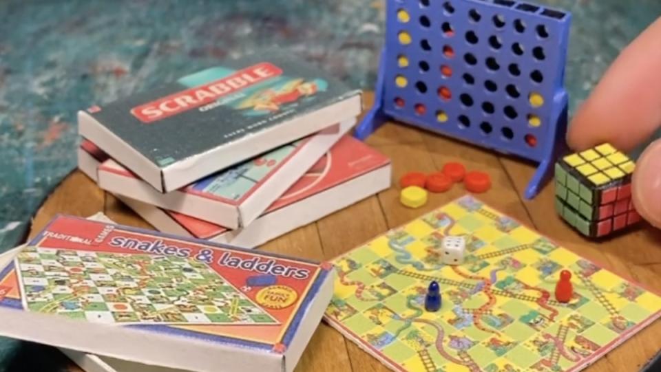 Miniature versions of famous games like Scrabble, Connect Four, and Snakes and Ladders, all together on a tiny board