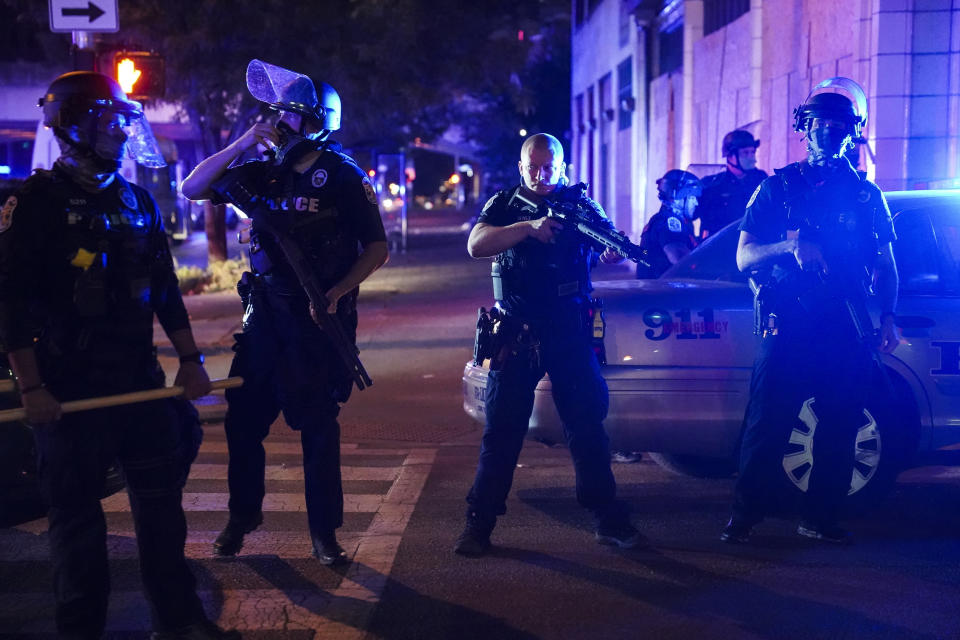 FILE - Police stand guard on the perimeter of a crime scene after a police officer was shot, Wednesday, Sept. 23, 2020, in Louisville, Ky. Recent shootings of police officers and protests that have left scores of officers injured are stark reminders of the dangers facing law enforcement around a country grappling with police killings of African Americans. (AP Photo/John Minchillo, File)