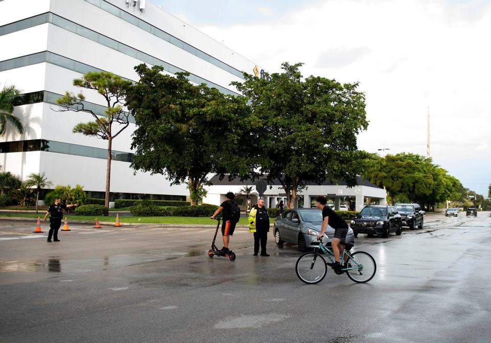 Boca Raton police officers direct traffic after the Town Center Mall was evacuated after a "swatting" attempt Saturday night on a Fortnite streamer.