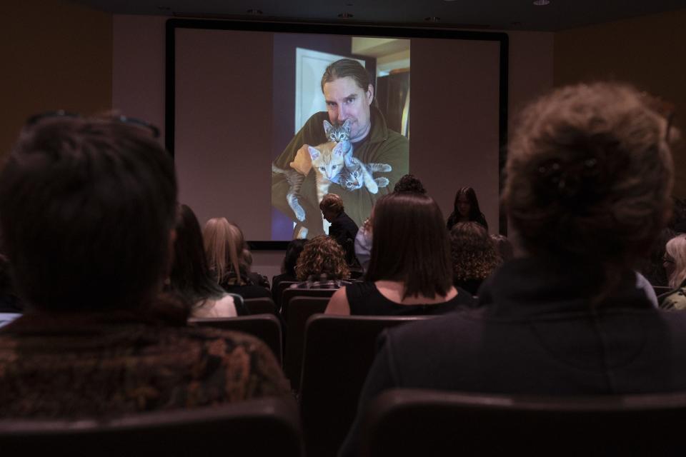 People watch a slideshow of Yeon-Su Kim and Corey Allen during a memorial service for couple at Cline Library Assembly Hall of NAU on Saturday, Dec. 10, 2022, in Flagstaff. The couple was lost at sea off the coast of Puerto Peñasco, Mexico, while kayaking on Thanksgiving.