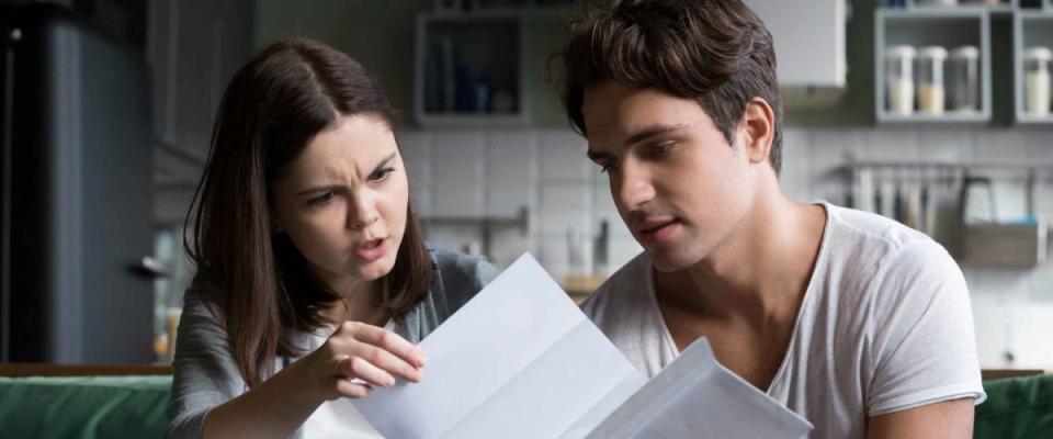 Couple looking at bills worried