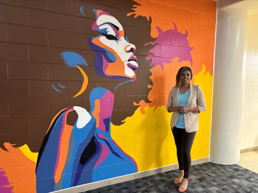 Artist E'lla Webber and her mural at the Kent County Correctional Facility. (May 6, 2024)