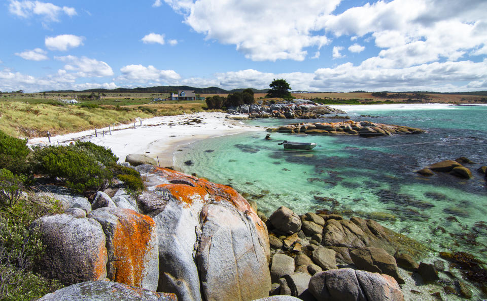 Bright orange lichen covers the rocks and gives the Bay of Fires its name. Tasmania, Australia.