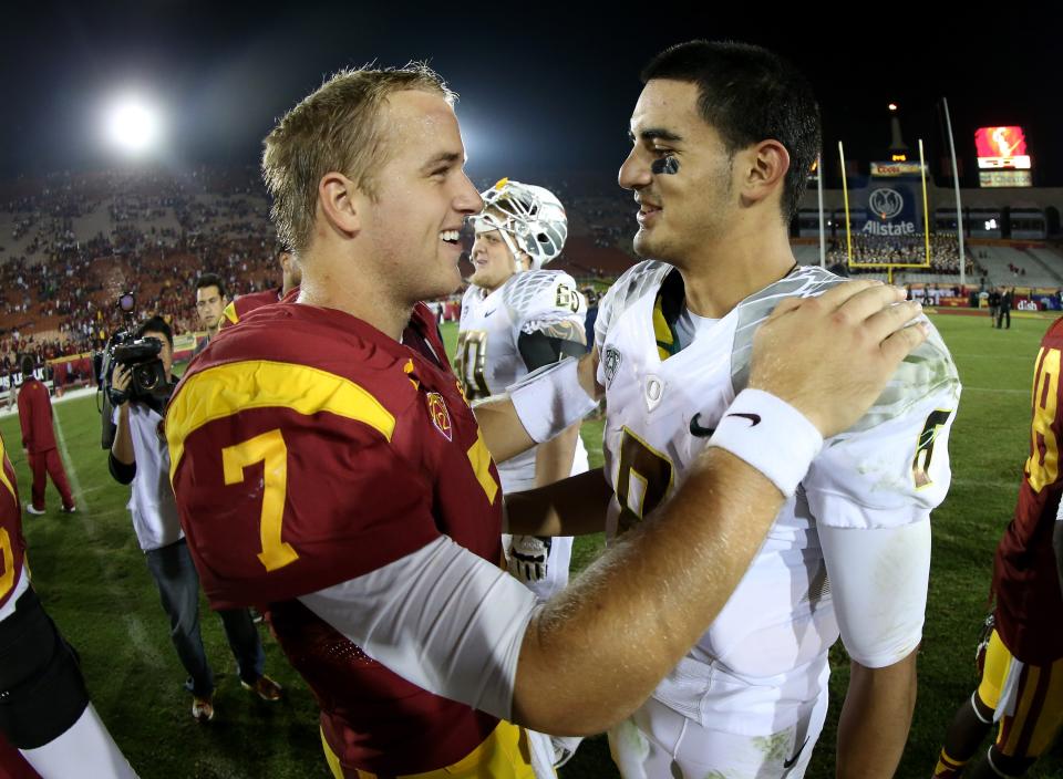 Quarterbacks Marcus Mariota #8 of the Oregon Ducks and Matt Barkley #7 of the USC Trojans meet after the game at the Los Angeles Memorial Coliseum on November 3, 2012 in Los Angeles, California. Oregon won 62-51. (Photo by Stephen Dunn/Getty Images)