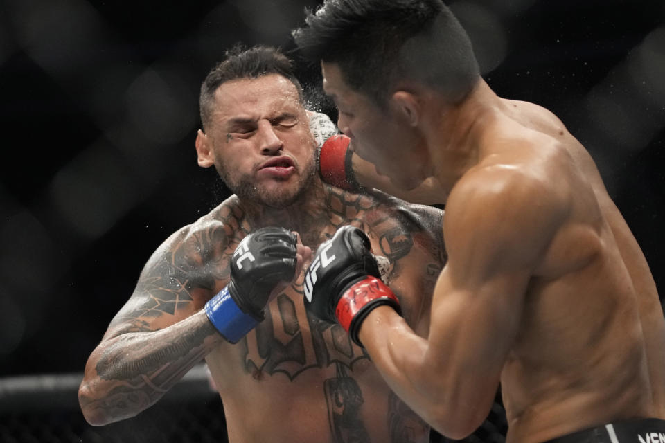 Li Jingliang hits Daniel Rodriguez in a 180-pound catchweight bout during the UFC 279 mixed martial arts event Saturday, Sept. 10, 2022, in Las Vegas. (AP Photo/John Locher)