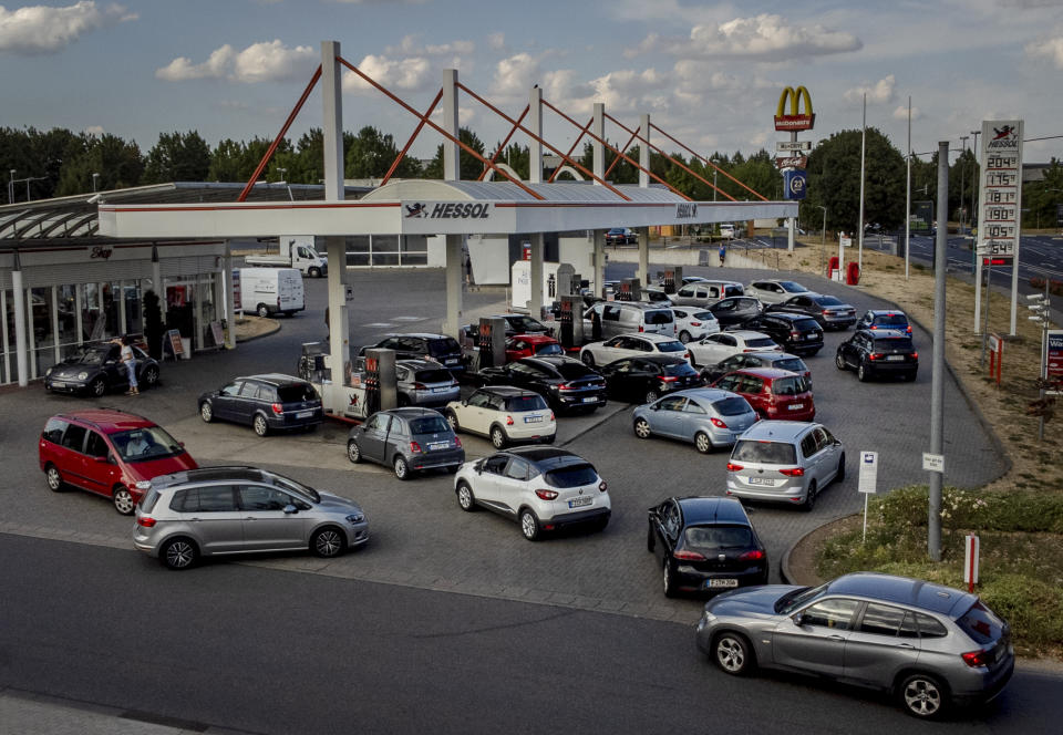FILE - People queue with their cars at a gas station in Frankfurt, Germany, on Aug. 31, 2022, the last day when the government's fuel prize discount is in effect. Major oil-producing countries led by Saudi Arabia and Russia have said they're throttling back supplies of crude — again. And this time, the decision to cut back was a surprise that is underlining worries about where the global economy might be headed. (AP Photo/Michael Probst, File)