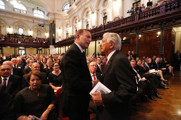 Australia's Prime Minister Tony Abbott (L) speaks to former prime minister Bob Hawke, at the Sydney Town Hall, on November 5, 2014