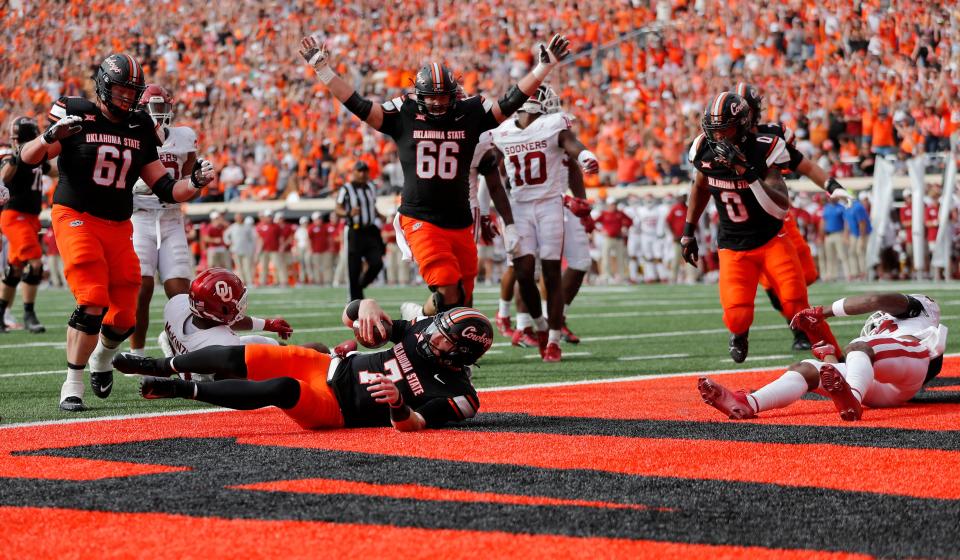 Oklahoma State's Alan Bowman (7) scores a touchdown in the first half of Saturday's game against OU at Boone Pickens Stadium in Stillwater.