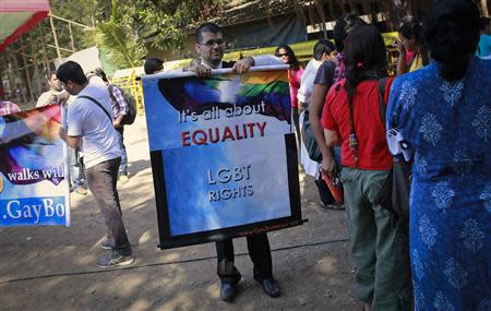 A gay rights activist folds a banner at a protest organised against the Supreme Court's order on gay sex in Mumbai December 11, 2013. REUTERS/Danish Siddiqui