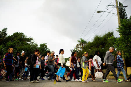 People cross the street to enter the Colombian Embassy in Havana, Cuba, January 12, 2018. REUTERS/Alexandre Meneghini