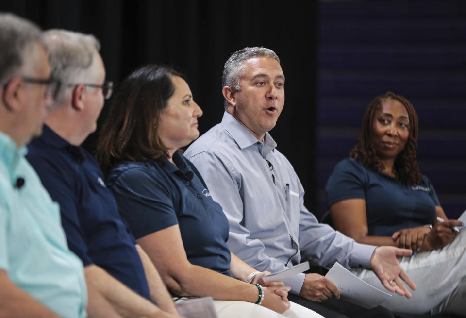 Dave Nowicki and other Ford Motor Co. team members speak during a panel discussion on the automaker's planned electric truck factory, at Haywood High School, Tuesday, June 21, 2022, in Brownsville, Tenn. (Patrick Lantrip/Daily Memphian via AP)