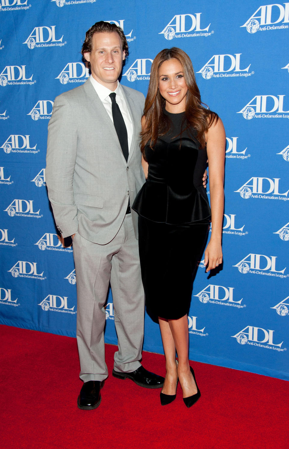 Actress Meghan Markle (R) in a black knee-length dress and her husband Trevor Engelson, in a grey suit, arrive at the Anti-Defamation League Entertainment Industry Awards Dinner at the Beverly Hilton on October 11, 2011 in Beverly Hills, California. 