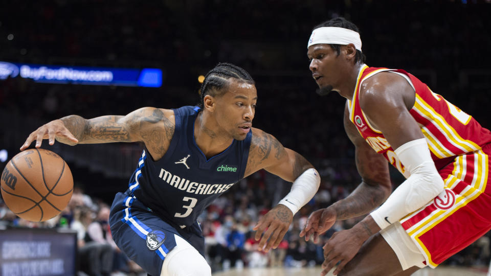 Atlanta Hawks Cam Reddish (22) defends Dallas Mavericks Trey Burke (3) during the second half of an NBA basketball game Thursday, Oct. 21, 2021, in Atlanta. (AP Photo/Hakim Wright Sr.)