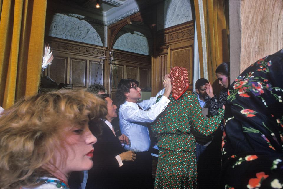 Yves Saint Laurent adjusting models backstage at his Paris collection in 1993. His muse, Loulou de la Falaise, is pictured in the foreground, and the famed hairdresser Alexandre is behind Saint Laurent. Photographed for French Vogue.