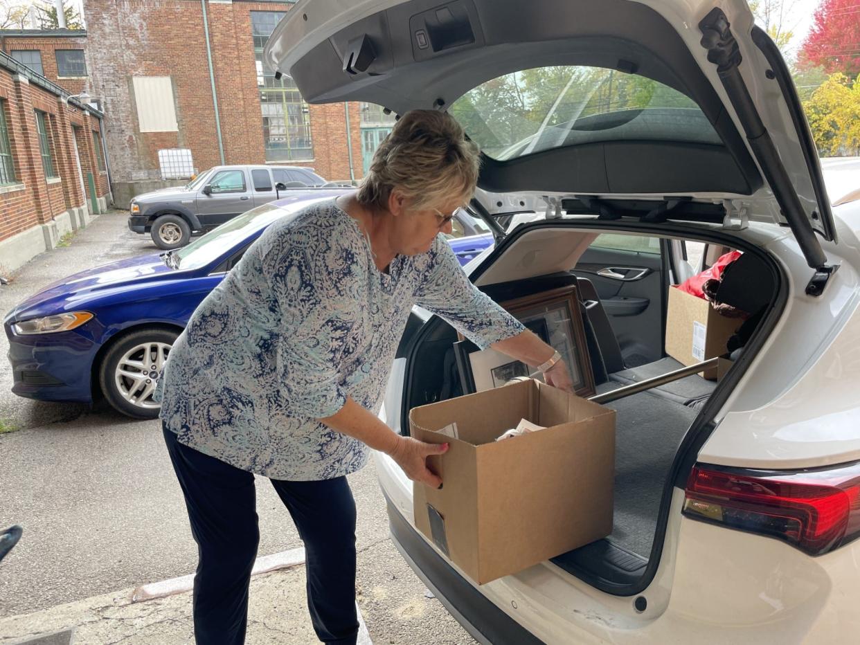 Donor Ileene Smith of Monroe unloads items at In the Spirit of Giving.