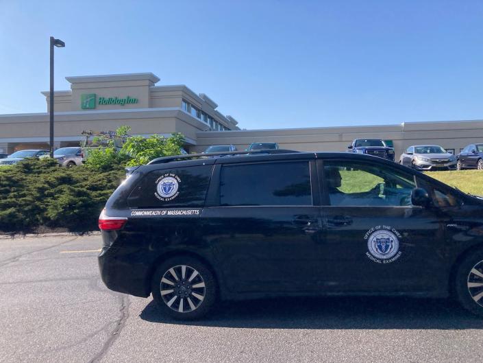 A vehicle from the state Medical Examiner's Office is seen parked outside the Holiday Inn in Marlborough, June 1, 2023. The Middlesex District Attorney's Office and Marlborough police reported that a person was in custody after an "apparent homicide" in the hotel's parking lot earlier on Thursday.