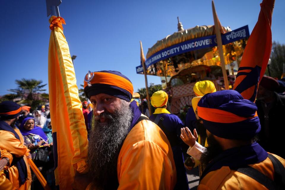 Parade leaders gather in front of the main float before the Vaisakhi parade in Vancouver, on Saturday, April 13, 2024. Vaisakhi is a significant holiday on the Sikh calendar, commemorating the establishment of the Khalsa in 1699 and marking the beginning of the Punjabi harvest year. THE CANADIAN PRESS/Darryl Dyck
