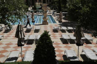 Groups of reclining pool chairs are separated to maintain social distancing between groups as a coronavirus safety precaution at the closed Bellagio hotel and casino, Wednesday, May 20, 2020, in Las Vegas. Casino operators in Las Vegas are awaiting word when they will be able to reopen after a shutdown during the coronavirus outbreak. (AP Photo/John Locher)