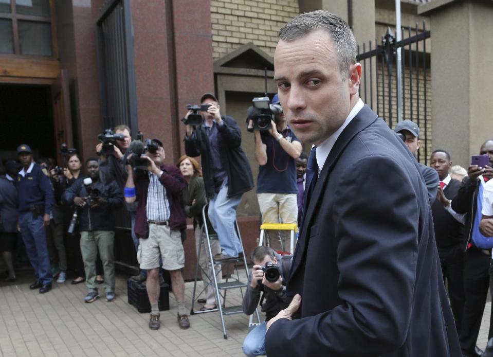 Oscar Pistorius looks back as he arrives at the high court in Pretoria, South Africa, Tuesday, May 6, 2014. Using witness accounts of a panicked nighttime phone call from Pistorius begging for help and his desperate pleas for Reeva Steenkamp to stay alive, the defense at his murder trial tried to reinforce its case Monday that the double-amputee Olympian fatally shot his girlfriend in a tragic error of judgment. (AP Photo/Themba Hadebe)