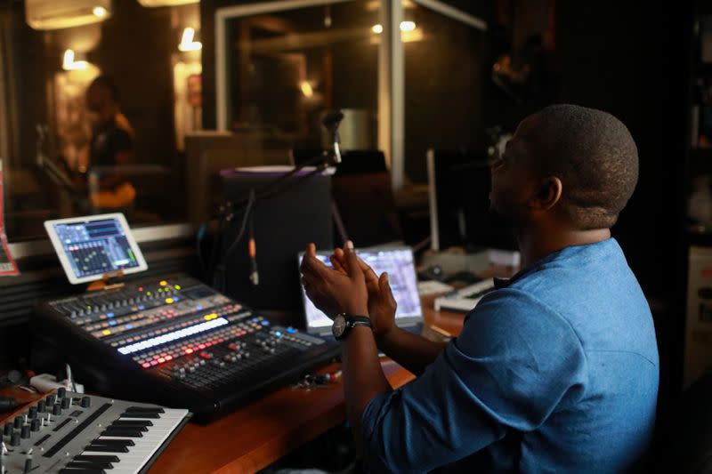 Bianca Okorocha's producer, Coldflames claps his hands for the band as they perform during rehearsals at the black star studio in Lagos