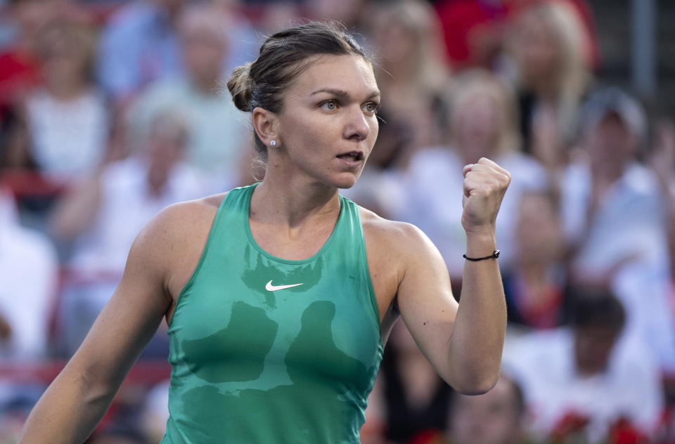 Simona Halep, of Romania, celebrates a point over Caroline Garcia, of France, during women's quarterfinal play at the Rogers Cup tennis tournament in Montreal on Friday, Aug. 10, 2018. (Paul Chiasson/The Canadian Press via AP)