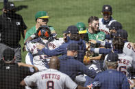 Oakland Athletics and Texas Rangers benches clear after Athletics' Ramon Laureano charged the dugout after being hit by a pitch thrown by Astros' Humberto Castellanos during the seventh inning of a baseball game Sunday, Aug. 9, 2020, in Oakland, Calif. (AP Photo/Ben Margot)