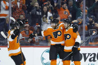 Philadelphia Flyers' Jakub Voracek, center, celebrates with Matt Niskanen, right, and Joel Farabee after scoring a goal during the second period of an NHL hockey game against the Pittsburgh Penguins, Tuesday, Jan. 21, 2020, in Philadelphia. (AP Photo/Matt Slocum)