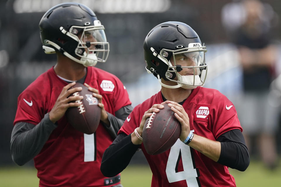 FILE - Atlanta Falcons quarterbacks Desmond Ridder (4) and Marcus Mariota (1) work during their NFL minicamp football practice Tuesday, June 14, 2022, in Flowery Branch, Ga. The Atlanta Falcons released quarterback Marcus Mariota on Tuesday, Feb. 28, 2023, in a move that was expected after the veteran was benched late in the 2022 season.The Falcons were 5-8 with Mariota as the starter before rookie Desmond Ridder started the final four games, winning two. (AP Photo/John Bazemore, File)