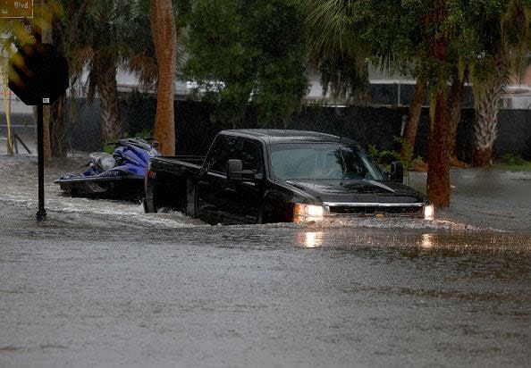 TARPON SPRINGS, FLORIDA - AUGUST 30: A truck passes through flooded streets caused by Hurricane Idalia passing offshore on August 30, 2023 in Tarpon Springs, Florida. Hurricane Idalia is hitting the Big Bend area of Florida. (Photo by Joe Raedle/Getty Images)