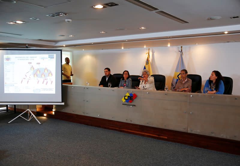 Venezuela's National Electoral Council (CNE) President Tibisay Lucena (C) speaks next to National Electoral Council rectors during a news conference in Caracas