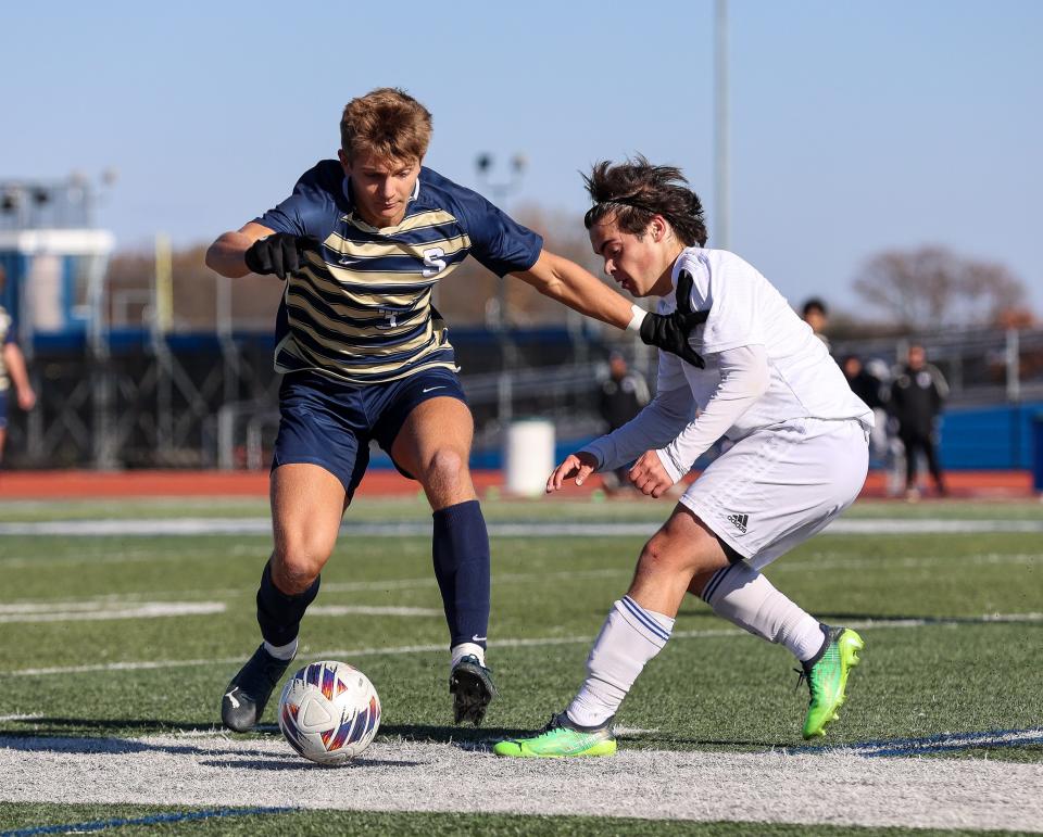 Salesianum’s Gannon Tolmie attempts to hold off Nicholas Livaditis of Charter of Wilmington.
