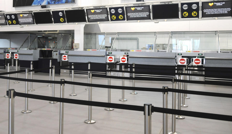 General view of the deserted Thomas Cook check-in counters at Birmingham airport in Birmingham, England, Monday, Sept. 23, 2019. Hundreds of thousands of travellers were stranded across the world Monday after British tour company Thomas Cook collapsed early Monday, immediately halting almost all its flights and hotel services and throwing employees out of work. (AP Photo/Rui Vieira)