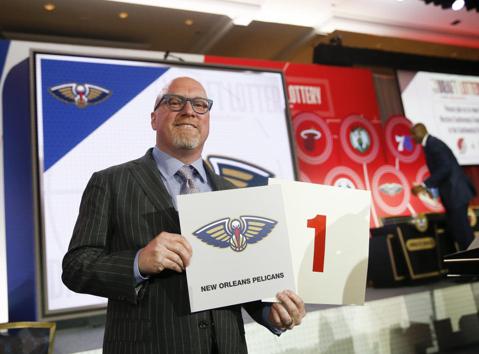 David Griffin, New Orleans Pelicans executive vice president of basketball operations, holds up placards after it was announced that the Pelicans had won the first pick during the NBA basketball draft lottery Tuesday, May 14, 2019, in Chicago. (AP Photo/Nuccio DiNuzzo)