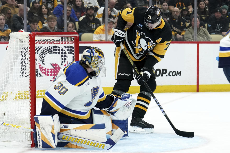 Pittsburgh Penguins' Evgeni Malkin (71) scores against St. Louis Blues goaltender Joel Hofer (30) during the second period of an NHL hockey game Saturday, Dec. 30, 2023, in Pittsburgh. (AP Photo/Matt Freed)