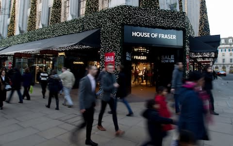 Shoppers walk past House of Fraser's Oxford Street store