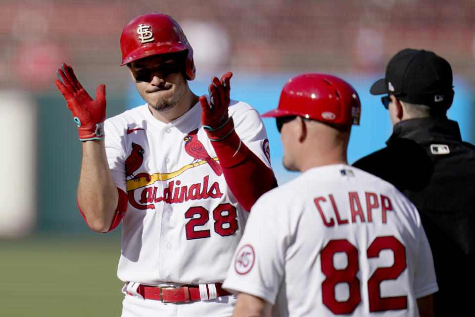 St. Louis Cardinals' Nolan Arenado (28) celebrates after hitting an RBI single as Cardinals first base coach Stubby Clapp (82) stands nearby during the third inning in the first game of a baseball doubleheader against the New York Mets Wednesday, May 5, 2021, in St. Louis. (AP Photo/Jeff Roberson)